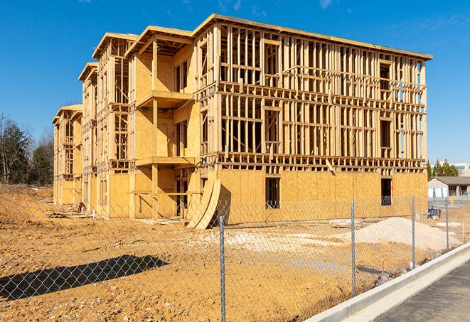 a construction site enclosed by temporary chain link fences, ensuring safety for workers and pedestrians in Mason Neck VA